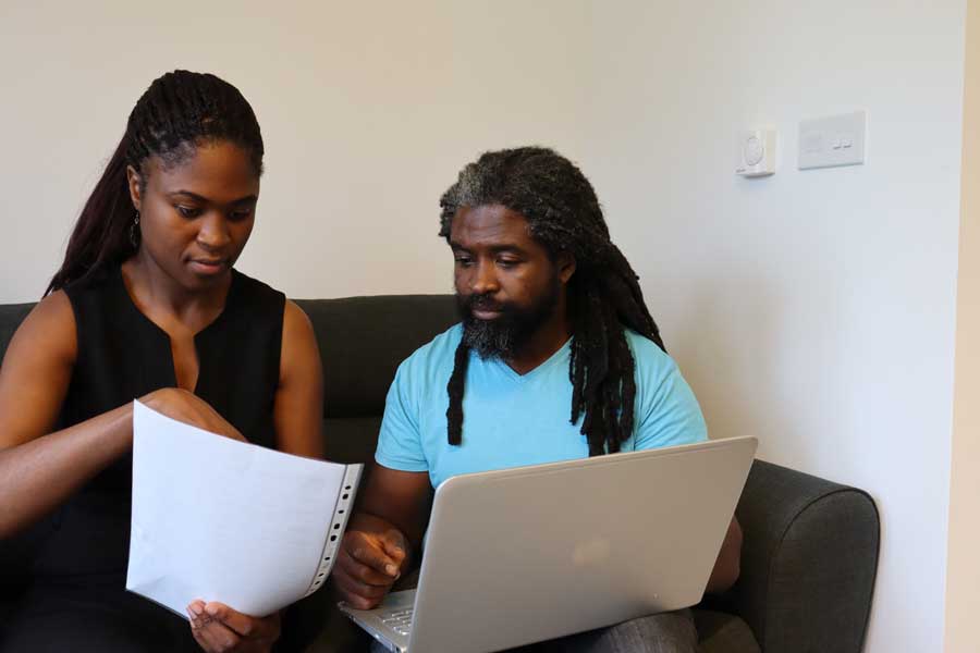Couple reviewing their purchase agreement they received from Your Home Sold Guaranteed Realty.