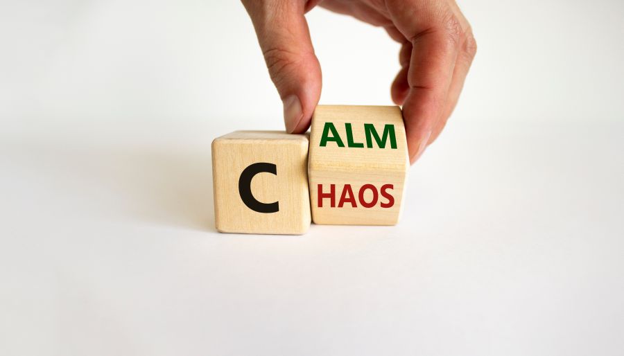 Stop chaos, time to calm. Male hand turns a wooden cube and changes the word 